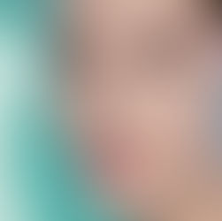 Close-up of a person's face with smooth, glowing skin and neutral makeup. Soft teal background, conveying a calm mood.