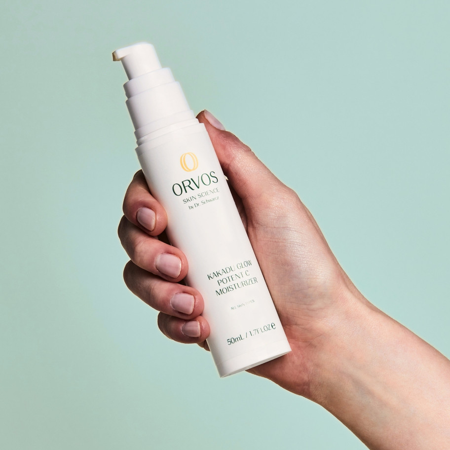Hand holding Orvos Kakadu Glow Potent C Moisturizer