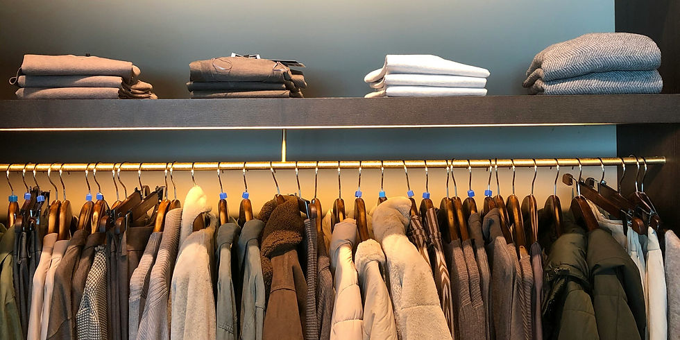 A display of neatly folded sweaters highlights warm fabrics and textures for the colder months.