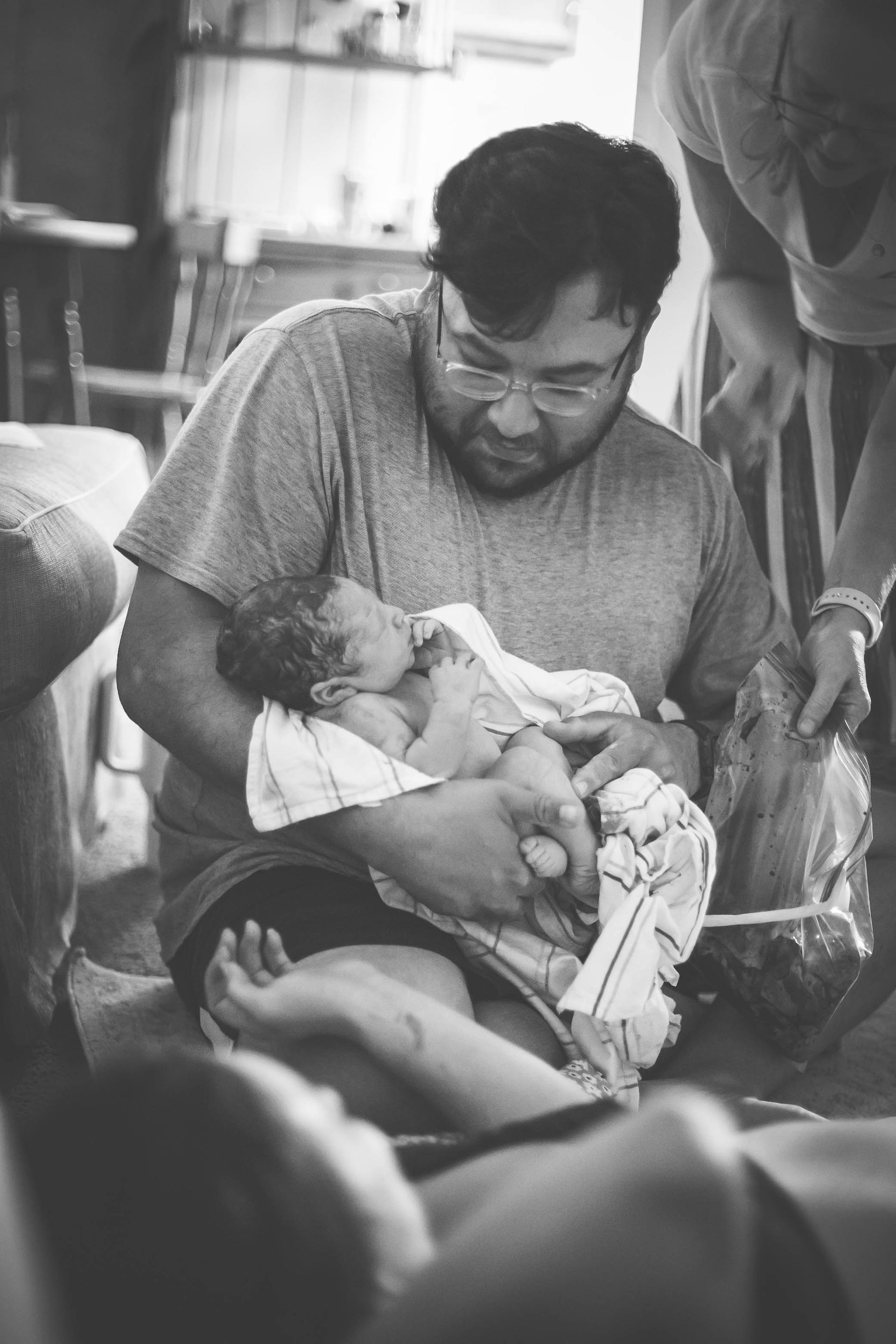 A dad holds his brand new baby.