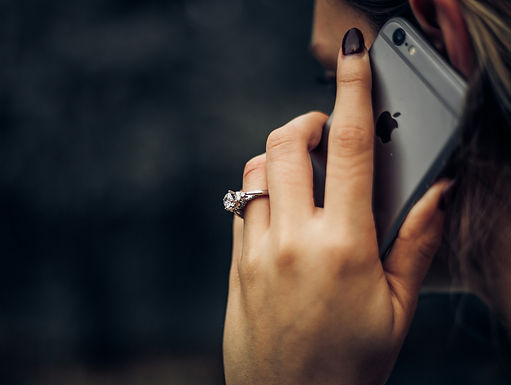 A woman on her cell phone, booking an appointment