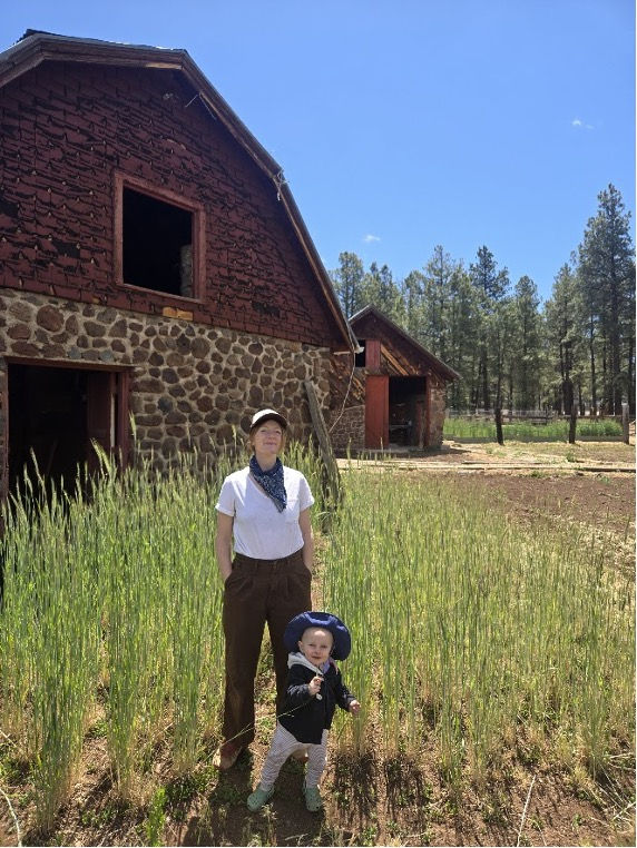 Image of Oakley and her daughter in front of the barn