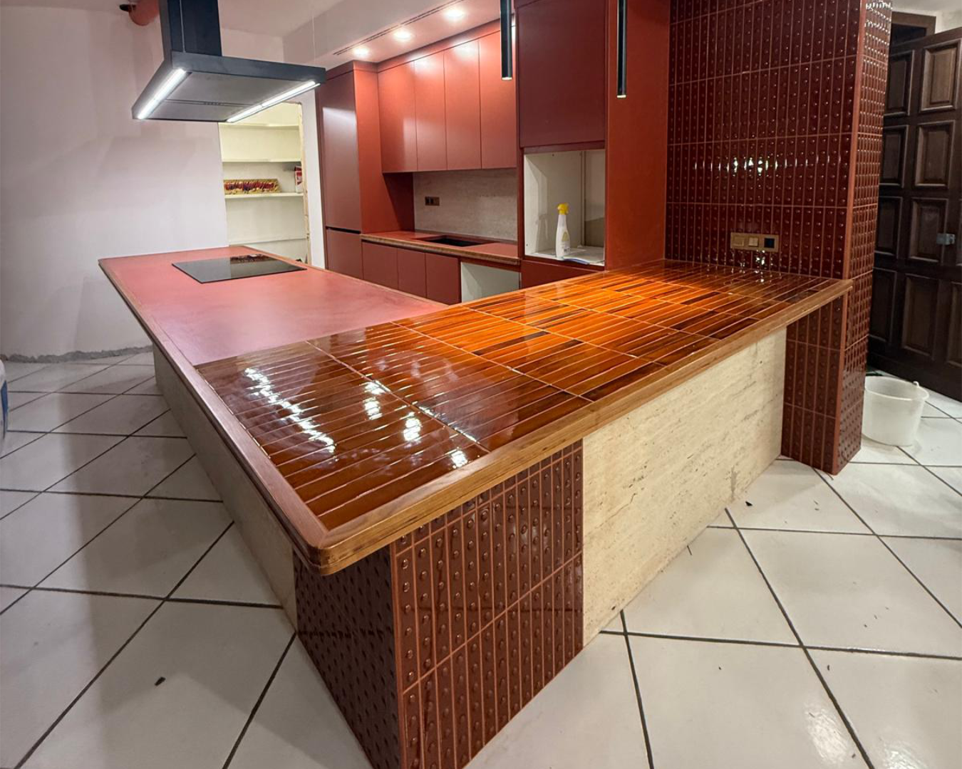Modern kitchen design with red cabinets and wood countertop PHASEZERO DESIGN.