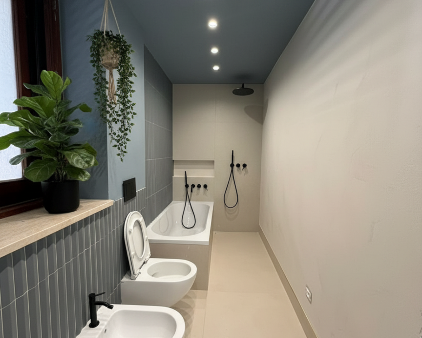 Modern bathroom with a toilet, bathtub, and shower designs. PHASEZERO DESIGN.