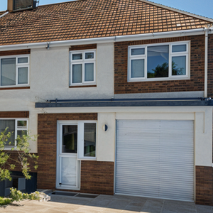 Two-story house with white garage and windows