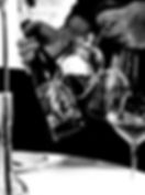 image of a person holding a bottle of wine and a wine glass