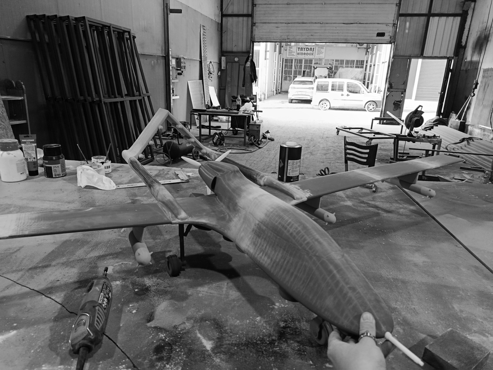 The production phase of the Bayraktar TB3 UAV model, including surface preparation, priming, and pre-painting technical processes after 3D printing.