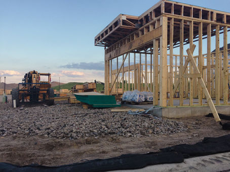 Residential construction site showing framing and active project coordination during a home build.