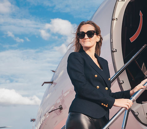 Elegant woman passenger boarding a JETUP luxury private jet