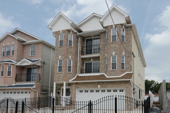 Modern multi-family residential building with balconies and contemporary design