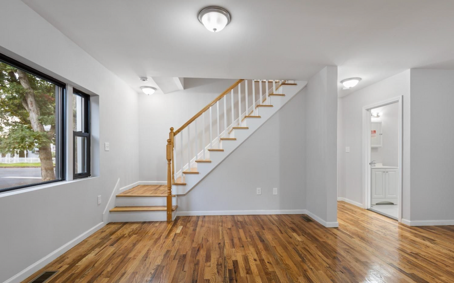 Interior staircase with hardwood flooring in fully renovated Old Bridge residence