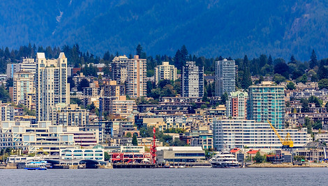 Residential neighborhood in North Vancouver during snowfall — snow plowing and de-icing services for townhomes and apartments
