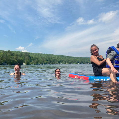 NSM students swimming in a lake in summertime.