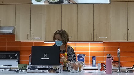 Woman teaching virtual cooking class with a computer