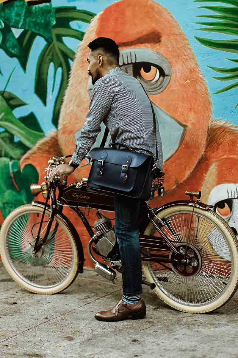Thumbnail: corporate man on a bike holding his beloved genuine leather satchel for work