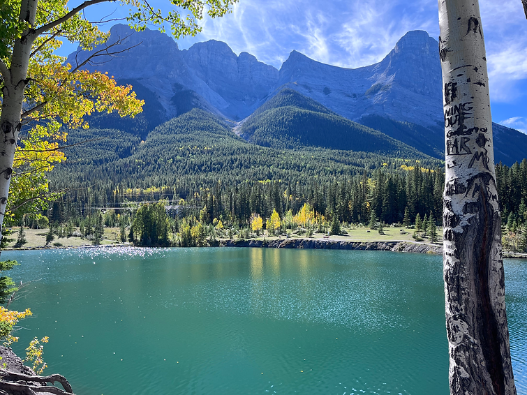 a beautiful view of a Canmore mountain range behind Quarry Lake