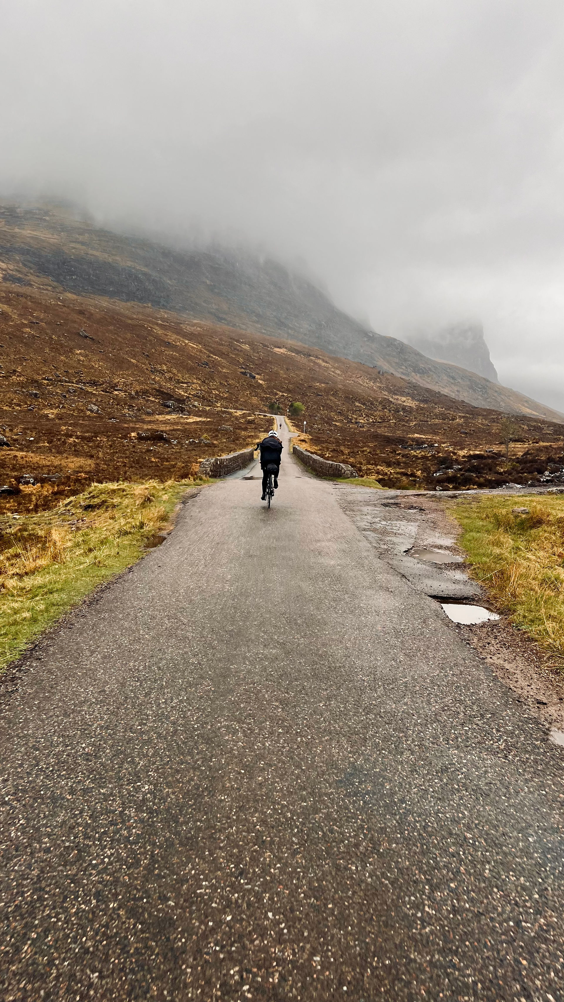 cyclist on a road in Scotland on the classic North Coast 500