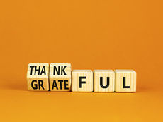 blank background and some scrabble letters that say thankful and grateful