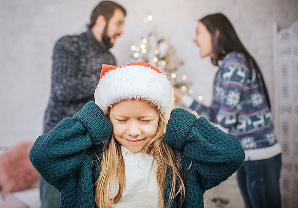 kid tries to cover ears to stop sound of parents arguing holoidays