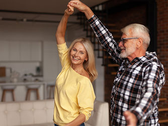 man and a woman holding hands twirl through a dancing move