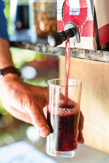 drawing red wine from a box into a glass