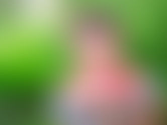 young women with braces on her teeth and wearing glasses cradles a wedge of watermelon in her hands as she smiles at the camera