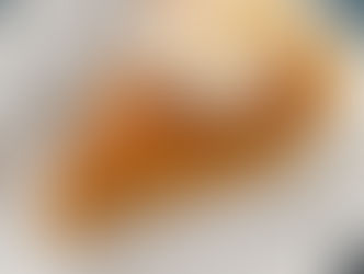 slice of sweet potato pie on a white plate and topped with whipped cream