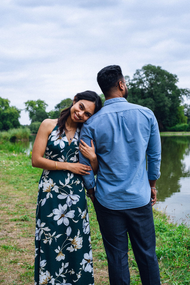 Two people embracing in a green landscape