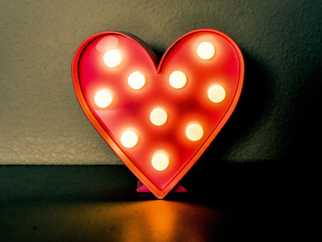Ornamental red heart with 10 bulbs lighting it up.