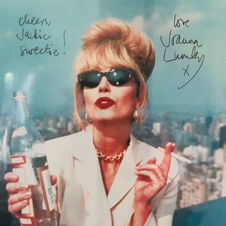 Joanna Lumley in character as Patsy from the TV show Absolutely Fabulous in her iconic pose with a cigarette and glass of champagne