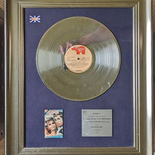 Silver disc presented to producer, empresario and manager Robert ‘Stiggy’ Stigwood to commemorate £100,000 of sales of the album soundtrack Grease.