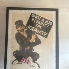 The broadcaster Kenny Everett holds a placard that reads "Snot a job in sight? Try Jobmate" The poster is for Capital Radio