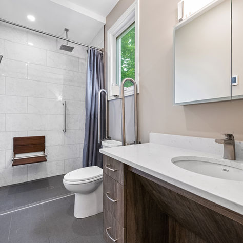 accessible bathroom renovation with barrier-free shower, pull down shower seat, grab bars, roll under vanity