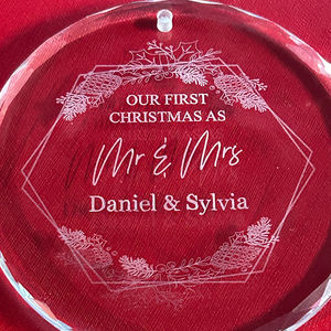 close up of an engraved crystal round ornament on a red background