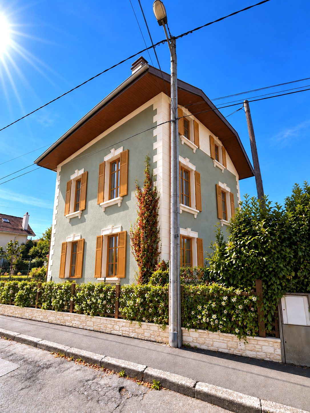 Maison de caractère rénovée : enduit vert d'eau, volets bois, modénatures claires