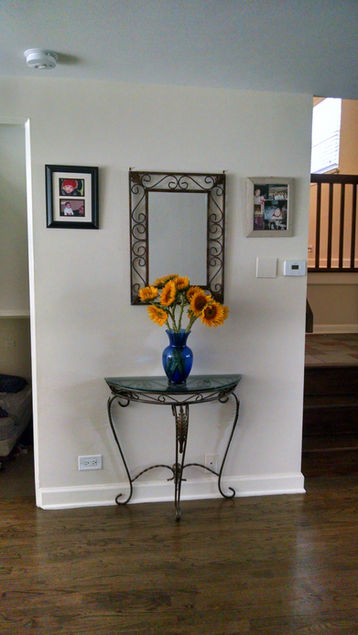 Sunflowers in blue vase on ornate table.