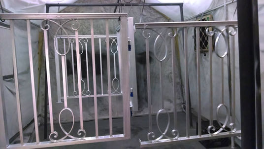 Metal gates with decorative swirl designs.