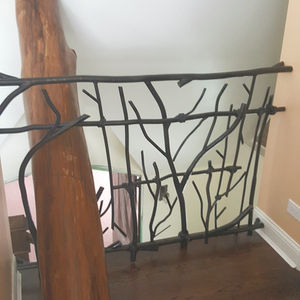 Ornate metal railing with branch-like design.
