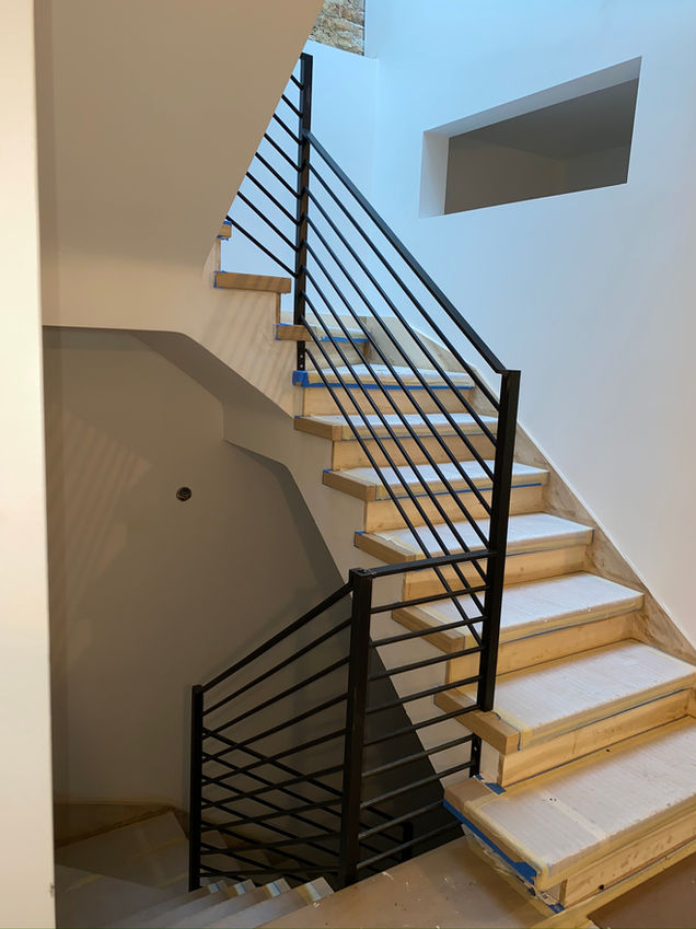a staircase with wooden steps and a metal railing