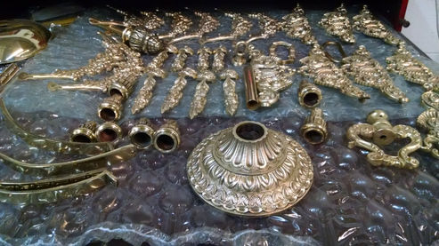Ornate metal objects displayed on a textured surface.