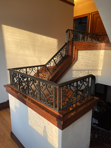 wrought iron railing installed on parapet wall going down a spiral stair case