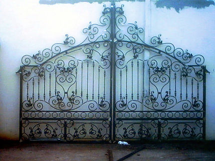 Ornate wrought iron gate with intricate design details.
