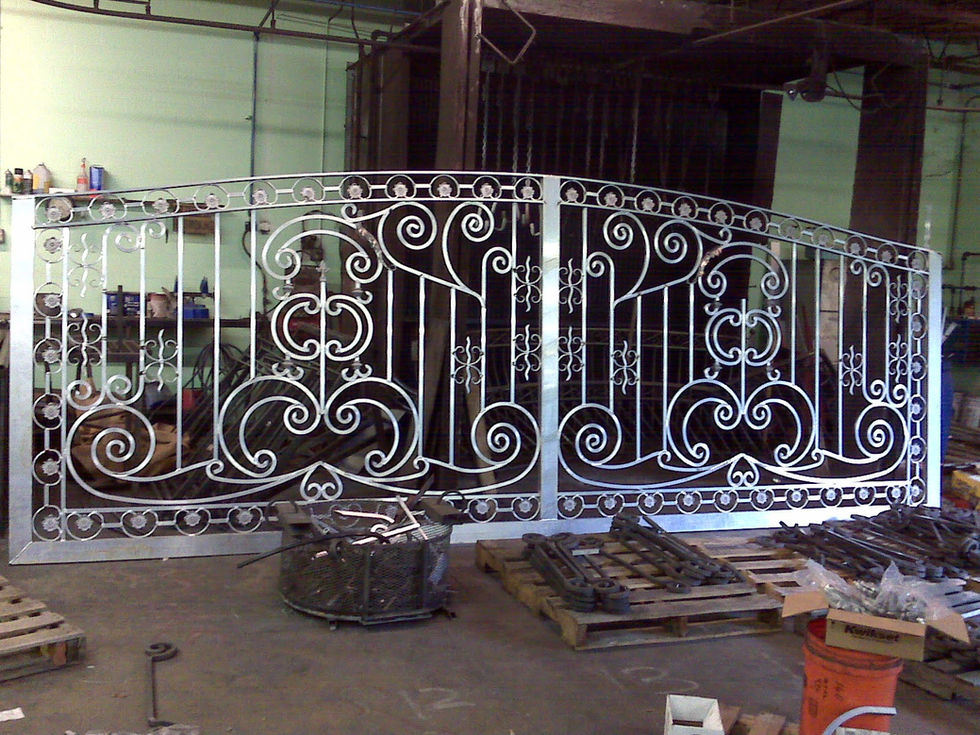 Ornate metal gate with intricate scrollwork design.