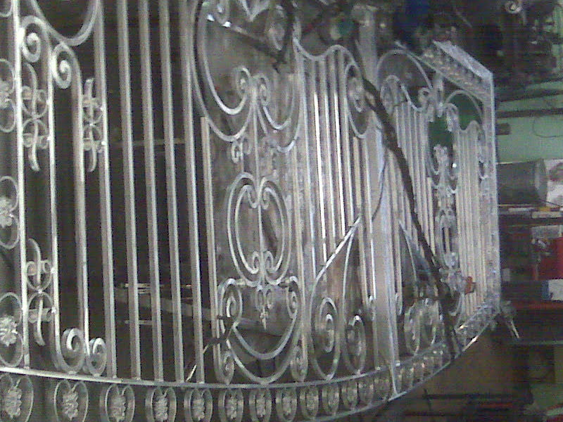 Ornate metal gate with intricate decorative patterns.