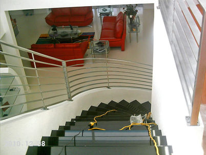 Modern staircase leading to stylish living area.