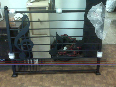 Metal railing with musical note design.