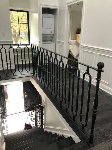 Elegant black railing in a modern interior space.