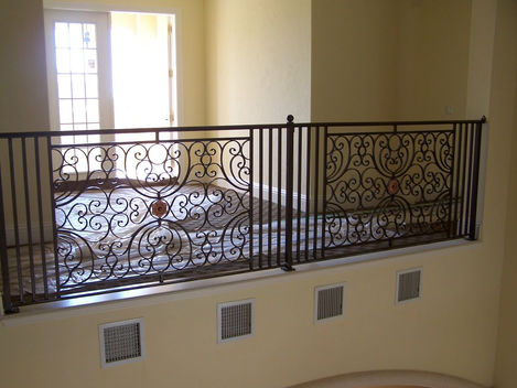 Ornate metal railing with intricate scrollwork design.