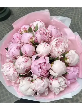 Large bouquet of pink peonies in light pink wrapping