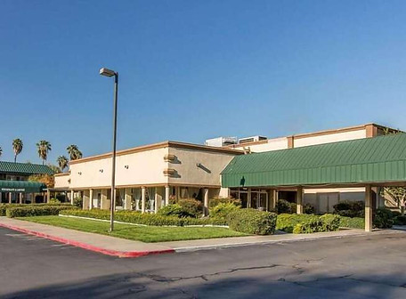 Single-story hotel building with a green roof and landscaped exterior in Los Angeles, CA.